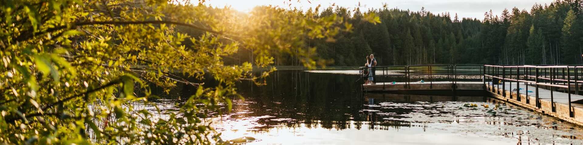 Chemainus lake fishing dock with sun setting in background