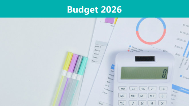 Calculator, budgeting papers, and pens lying on table