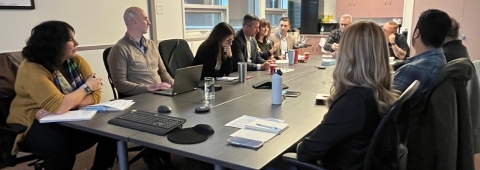 People sitting around a table in meeting room